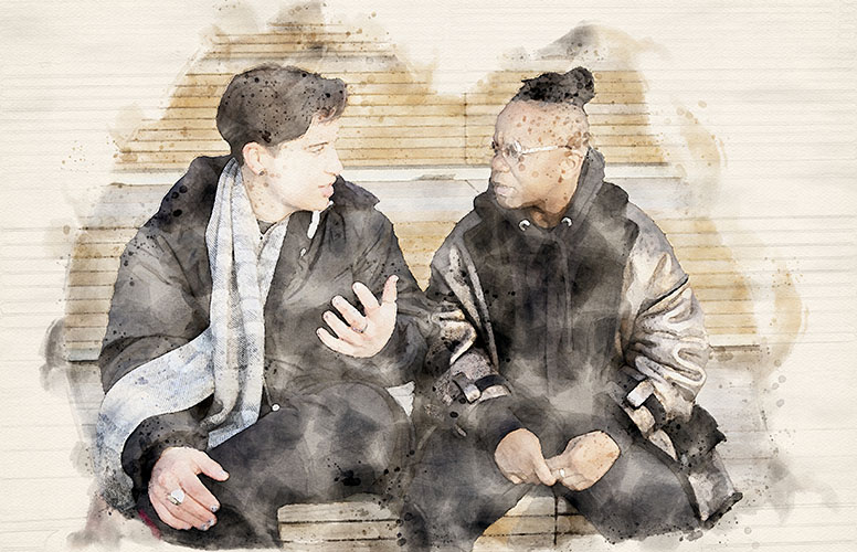 two transmasculine people sitting together and
having a serious conversation